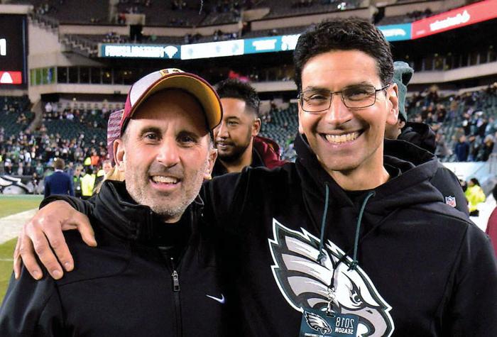 Matt Pepe and Chris Annunziata on the sidelines of a football field